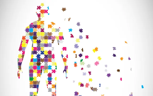 Afbeelding van een mens bestaand uit puzzelstukjes.