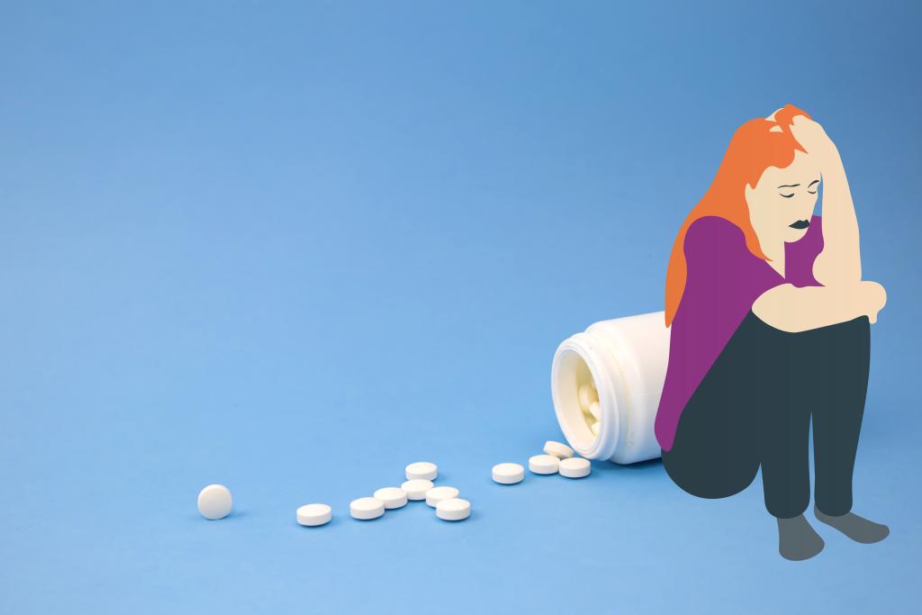 Een meisje leunt tegen een omgevallen potje waar medicijnen uit rollen. 